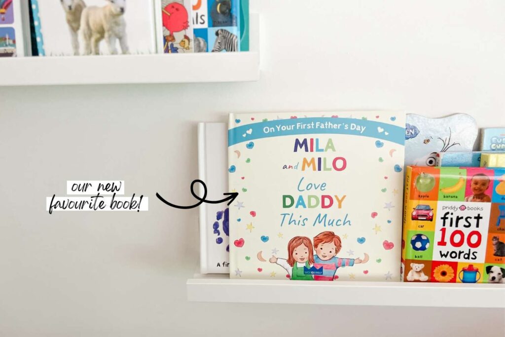 Our customized book that we gifted to dad on his first fathers day sitting on a shelf with our other books for the babies.