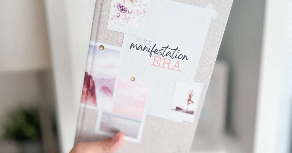 The front cover of the 'In my Manifestation Era' notebook - it has a beige background with pink-ish themed poloroid photos on it. 